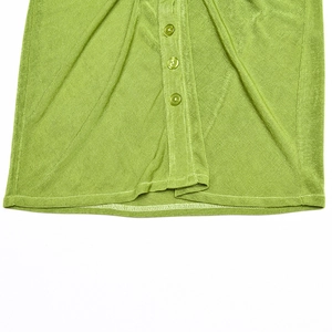 Detailed macro view of the green ribbed knit texture and matching buttons on this mini dress