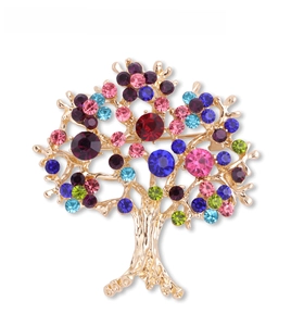 Close-up of a colorful tree-shaped brooch with multicolored rhinestones on a gold frame