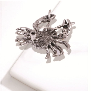 Reverse view of silver crab brooch showing pin clasp and detailed metal texture