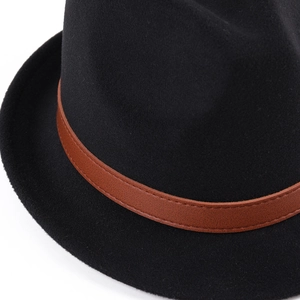 Macro shot of black felt hat showing brown leather band texture and precise stitching
