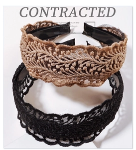 Detail of hollow lace embroidery headbands in black and champagne colors with floral texture