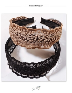 Detailed view of wide lace headbands in beige and black with intricate floral embroidery