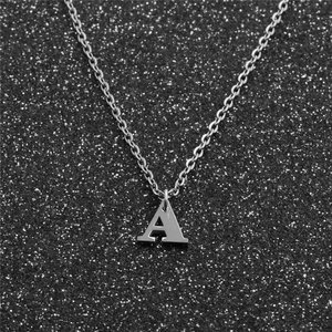 Detailed view of capital letter A pendant on a fine stainless steel chain necklace