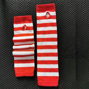 Detail of red and white wide striped knitted arm warmers with thumb hole design