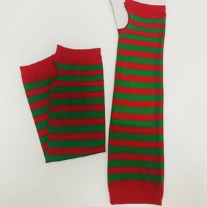 Detail of red and green striped knit arm warmers with thumb hole design on white background