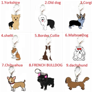 Nine diverse dog breed metal keychains including Corgi and Bulldog with lobster clasps