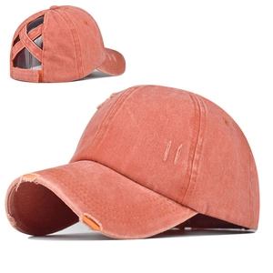 Détail de la casquette délavée orange-rose avec sangles croisées pour queue de cheval