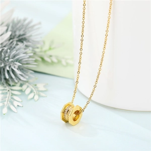 Golden hexagon pendant necklace with embedded diamonds on a minimalist display