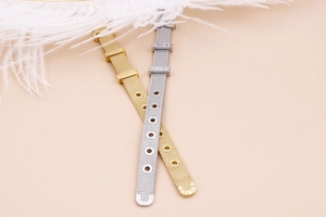 Detail of adjustable 18k gold plated mesh band with diamond accent and infinity design