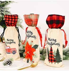 Three burlap Christmas wine bottle bags with plaid accents and Merry Christmas print