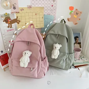 Zaini in nylon rosa pastello e verde salvia con ciondoli a forma di orsetto, stile casual