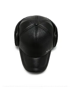Top view of black leather winter baseball cap with plush ear flaps and fine texture