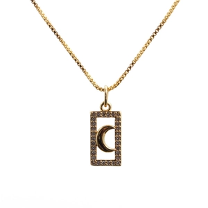 Close-up of golden box chain necklace with rectangle moon and star zircon pendant
