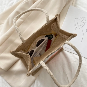 Minimalist jute tote bag with rope handles showing large capacity for daily items