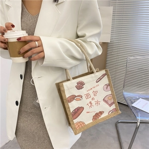 Detail of canvas lunch bag showing the cute bread illustration and wide side gusset design