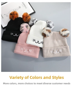 Detail view of four colorful knitted cat-ear hats with faux fur pom-poms and embroidery