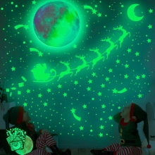 Luminous Christmas wall stickers showing Santa on a sleigh and glowing stars in the dark