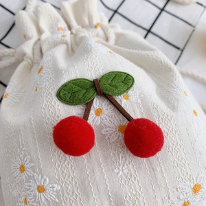 Cute canvas bucket bag with embroidered daisies and plush red cherry pom poms