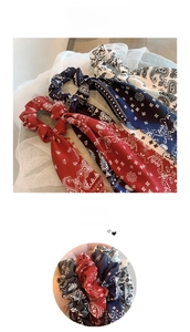 Close-up of paisley silk-like scrunchies with long ribbons in red, blue, and black