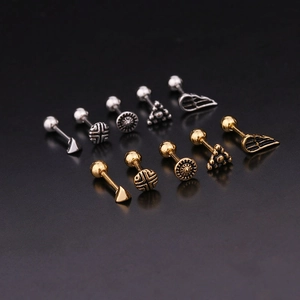 Vintage stainless steel ear stud set with sun, cross, and wing designs in gold and silver