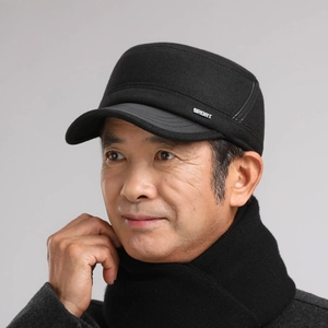 Detail view of winter black flat top hat for men with metal Sport logo and thick wool texture