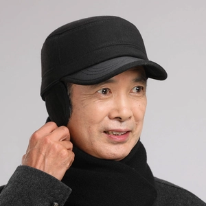 Detail of winter flat top hat for men featuring foldable ear flaps and warm thick fabric