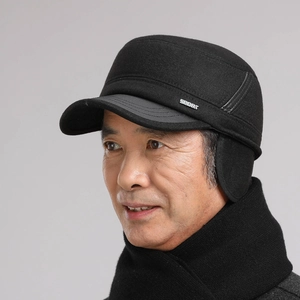 Detail of winter thermal flat cap for men with warm ear flaps and SPORT metal logo