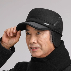 Detail view of winter flat cap for men featuring ear protection and metal SPORT badge