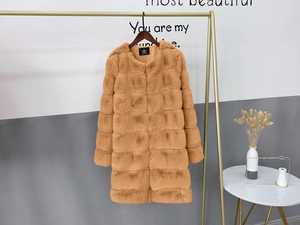 Detail of light brown faux fur coat showing tiered stitching and round neck on hanger