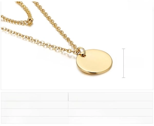 Close-up of a 13mm round gold pendant with thin stainless steel chain details