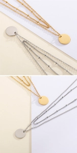 Detail view of layered gold and silver necklaces with minimalist round pendants