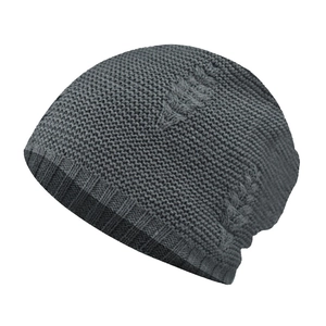 Detail of dark grey knit beanie showing leaf-shaped cable patterns and ribbed cuff