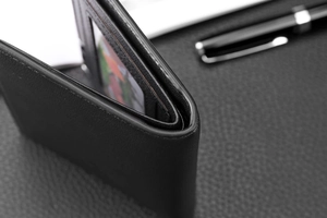 Close-up of black leather wallet stitching with multiple card slots and detailed texture