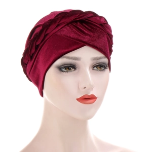 Detail of wine red velvet turban showing the braided twist texture on a mannequin
