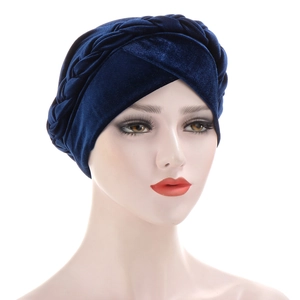 Close-up of dark blue velvet turban hat showing intricate braided details and soft texture