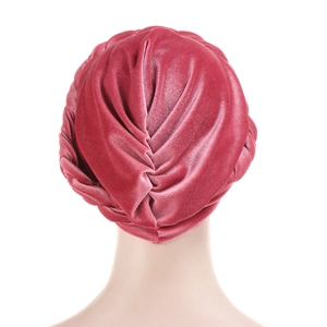 Detail of pink velvet turban cap showing braided twist texture and soft fabric luster