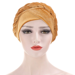 Close-up of the braided velvet turban hat in ginger yellow on a mannequin head