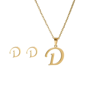 Detail of gold-plated stainless steel necklace and earrings set featuring letter D charm