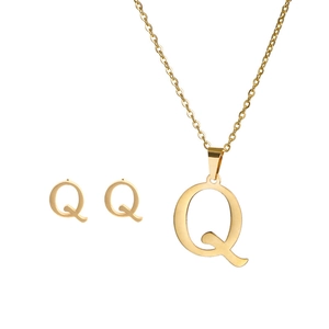 Close-up of golden stainless steel minimalist letter Q necklace and stud earrings set