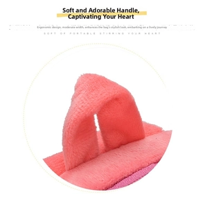 Close-up of a pink plush handle on a cartoon canvas backpack for toddlers and kids