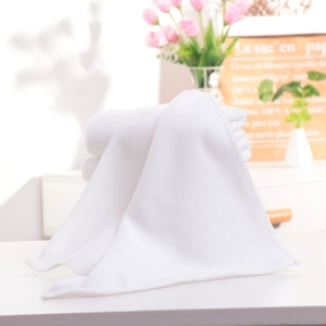 Close-up of white hotel cotton towel with premium soft texture and durable stitched edges