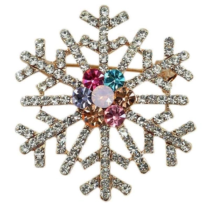 Close-up of golden snowflake brooch with colorful rhinestones and intricate details