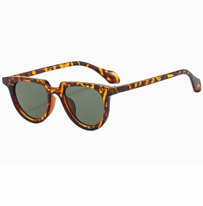 Detailed 45-degree angle view of vintage tortoise shell sunglasses with green lenses