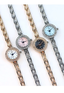 Detailed view of luxury quartz watches with rhinestone bezels in gold and silver colors
