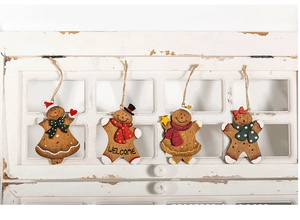 Detailed view of hand-painted wooden gingerbread man ornaments with Welcome sign