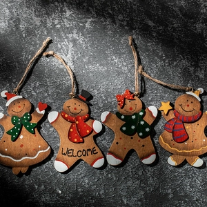 Set of four wooden gingerbread man Christmas tree ornaments with jute ropes and stars