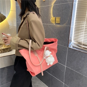 Detailed side view of pink high-capacity tote bag with a cute white sheep charm