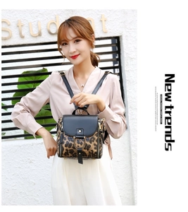 Detail of leopard print backpack with flip cover, metal buckle and New Trends text