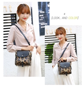 Detail showing leopard print shoulder bag with gold horseshoe buckle and side zippers