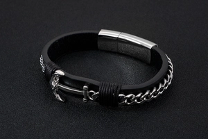 Macro detail of men's leather anchor bracelet with silver chain and magnetic clasp